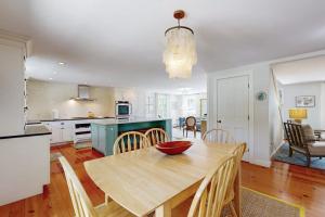 a kitchen and dining room with a table and chairs at Blissful Island Haven in Oak Bluffs