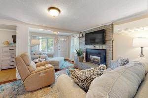 a living room with a couch and a fireplace at Sunset Cove Retreat in Wareham