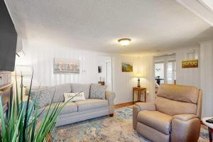 a living room with a couch and a chair at Sunset Cove Retreat in Wareham