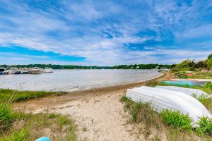 a sandy beach with boats on the water at Great Pond Escape in Falmouth