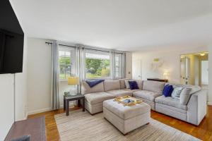 a living room with a couch and a table at Great Pond Escape in Falmouth