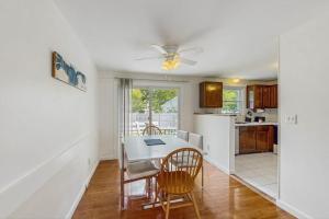 a kitchen and dining room with a table and chairs at Great Pond Escape in Falmouth