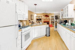 a large kitchen with white cabinets and white appliances at Beaconhill Road 68 in Ocean Pines