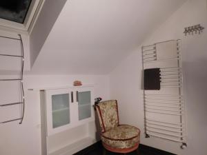 a white room with a chair and a window at Agroturystyka pod Czarną Sosną in Biały Ług