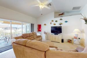 a living room with two couches and a flat screen tv at Sunny Way in Rotunda-West