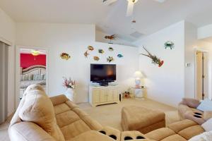 a living room with two couches and a flat screen tv at Sunny Way in Rotunda-West