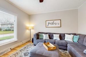 a living room with a couch and a table at South Haven Retreat in South Haven