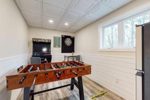 a ping pong table in a room with at South Haven Retreat in South Haven