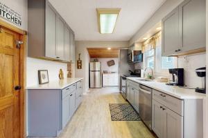 a large kitchen with white cabinets and a refrigerator at South Haven Retreat in South Haven +19 photos