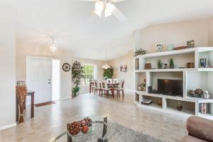 a living room with a table and a dining room at Marco Sands in Marco Island