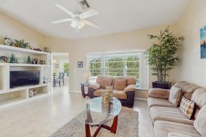 a living room with a couch and a table at Marco Sands in Marco Island