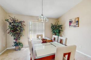 a dining room with a table and chairs and a chandelier at Marco Sands in Marco Island