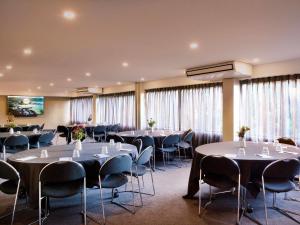a conference room with tables and chairs and windows at Mövenpick Hotel Wellington in Wellington +120 photos