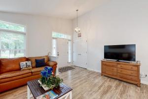 a living room with a couch and a flat screen tv at Coral Shells in Ocean Pines