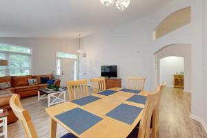 a dining room and living room with a table and chairs at Coral Shells in Ocean Pines