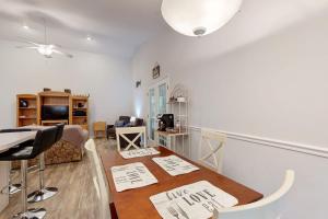 a living room with a table and a dining room at Coral Shells in Ocean Pines +21 photos