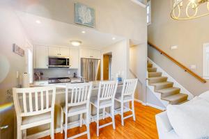 a kitchen and dining room with a table and chairs at Seabury Serenity in New Seabury