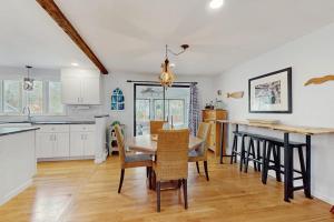 a kitchen and dining room with a table and chairs at The Blue Whale Cottage in Brewster
