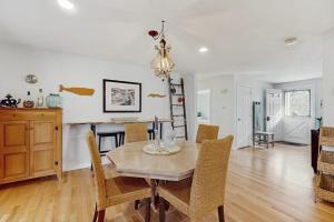 a dining room with a table and chairs at The Blue Whale Cottage in Brewster