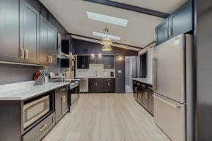 a large kitchen with wooden floors and stainless steel appliances at La Casa Chikaming in Union Pier