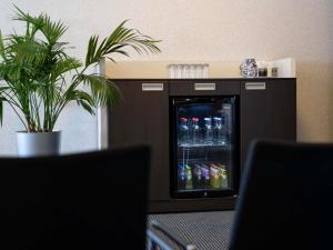 a refrigerator with drinks in it in a room at Mercure Hotel Zwolle in Zwolle