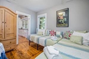 a living room with two beds and a couch at Hydrangea House in New Buffalo