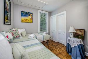 a living room with two beds and a window at Hydrangea House in New Buffalo +16 photos