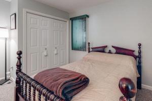 a bedroom with a bed with a wooden frame at Tranquil Woods in Ocean Pines