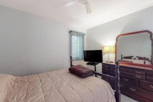 a bedroom with a bed and a large mirror at Tranquil Woods in Ocean Pines +14 photos