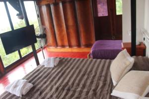 a bedroom with two beds in a room with windows at El Amado in General Alvear