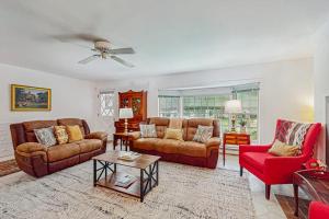 a living room with two couches and a table at The CAVU Mansion on Bellevue in Oklahoma Heights