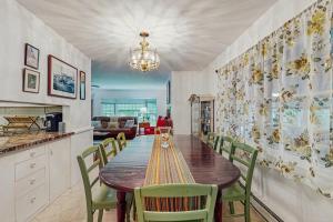 a dining room with a wooden table and chairs at The CAVU Mansion on Bellevue in Oklahoma Heights