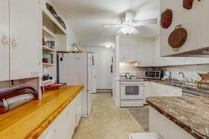 a kitchen with white cabinets and a white refrigerator at The CAVU Mansion on Bellevue in Oklahoma Heights