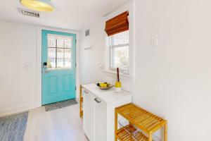 a kitchen with a blue door and a white counter at Calm Waters in Bourne +17 photos