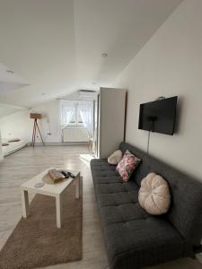 a living room with a couch and a table at Prestige in Arandelovac