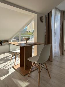 a dining room with a table and two chairs at Prestige in Arandelovac