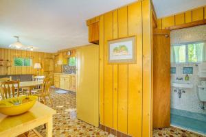 a kitchen with wooden walls and a table and a dining room at Grandma's Sandbox in Beulah