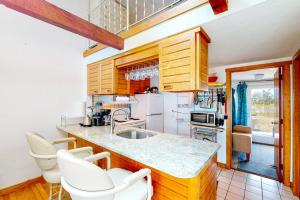 a kitchen with wooden cabinets and white appliances at Riviera Sunset in Chatham
