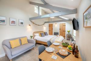 a living room with a bed and a dining table at 1 Bed in Abergele oc-bow134 in Llanfair Talhaiarn