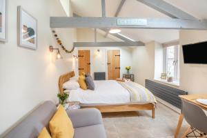 a bedroom with a large bed and a couch at 1 Bed in Abergele oc-bow134 in Llanfair Talhaiarn