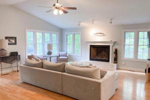 a living room with a couch and a fireplace at Ravenswood Pool House in Sawyer