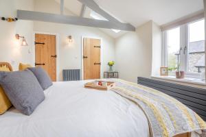 a bedroom with a large white bed and a window at 1 Bed in Abergele oc-bow134 in Llanfair Talhaiarn