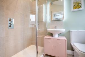 a bathroom with a sink and a glass shower at 1 Bed in Abergele oc-bow134 in Llanfair Talhaiarn +24 photos