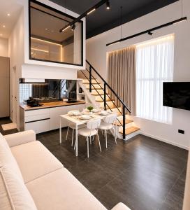 a living room with a white couch and a table at ALZETA Aparthotel in Durrës