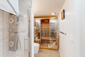 a bathroom with a shower and a toilet and a sink at Tranquil Getaway in Wellfleet
