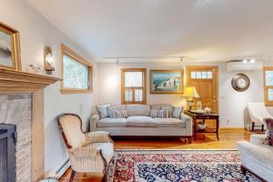 a living room with a couch and a fireplace at Tranquil Getaway in Wellfleet