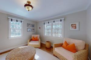 a living room with two chairs and a table at Cotuit Mannor in Cotuit