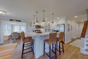 a kitchen with a large island with bar stools at Cotuit Mannor in Cotuit