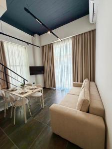 a living room with a couch and a table at ALZETA Aparthotel in Durrës