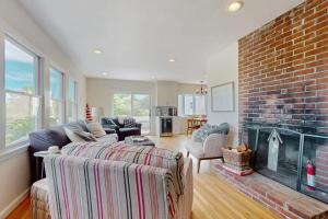 a living room with a couch and a fireplace at Harbor Point Cottage in Bourne